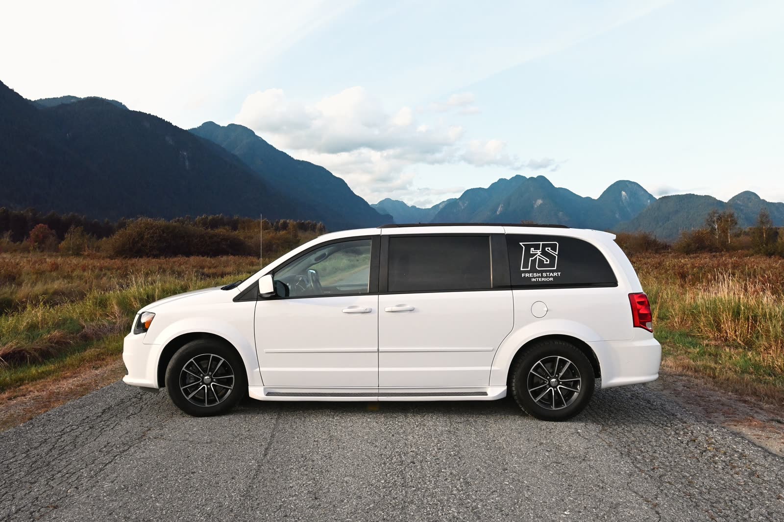 The FreshStart Interior van, a white Dodge Grand Caravan with the FS logo on the rear side window