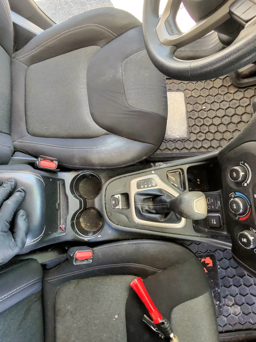 SUVs: the console of a Jeep Cherokee being cleaned