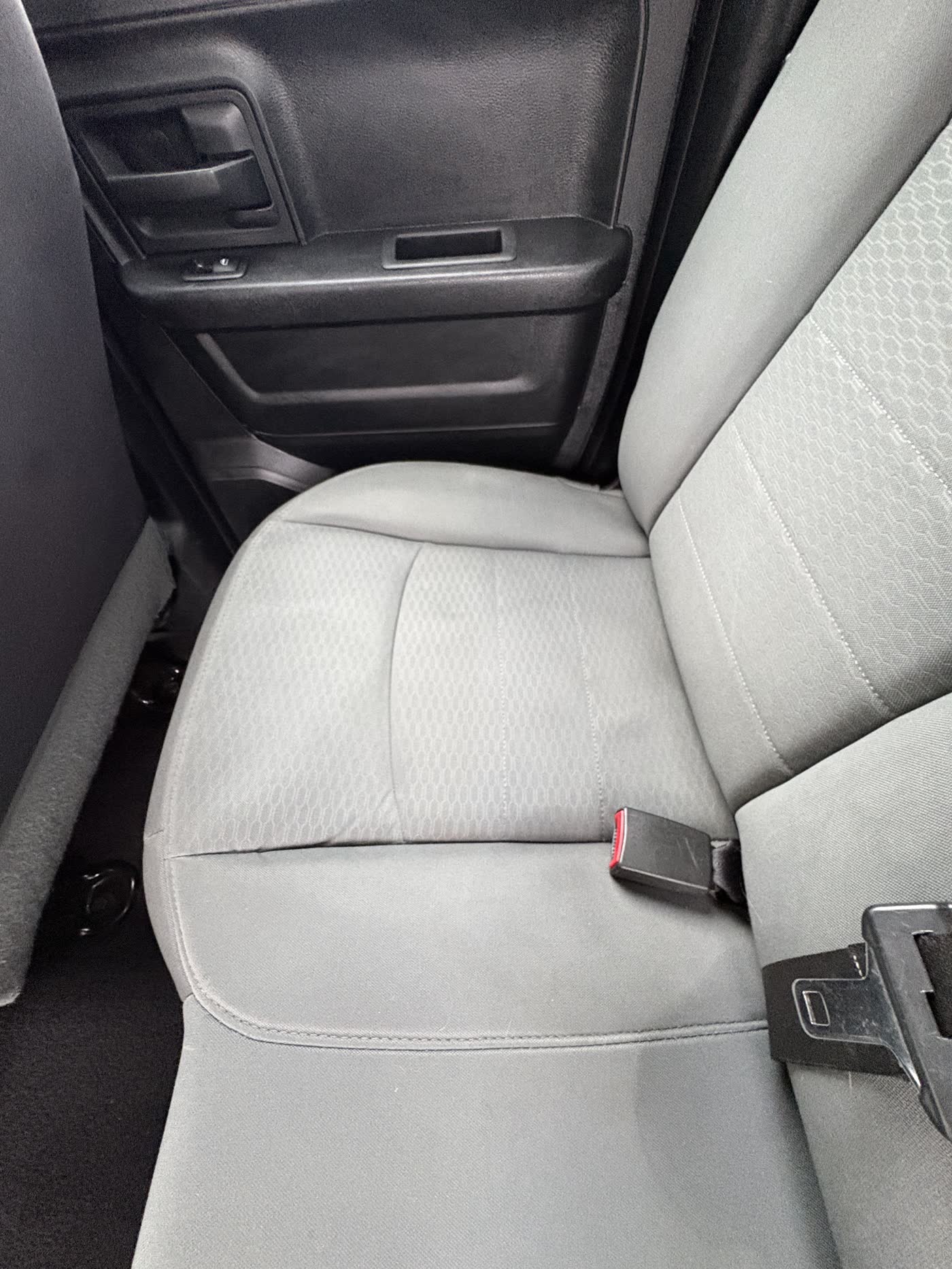 A cleaned grey cloth seat in a work truck