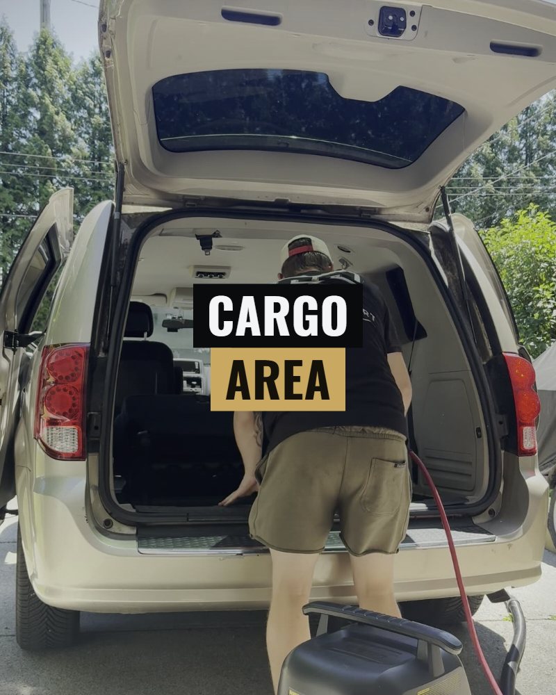 Cargo area: the cargo area of a minivan being cleaned through the open hatch
